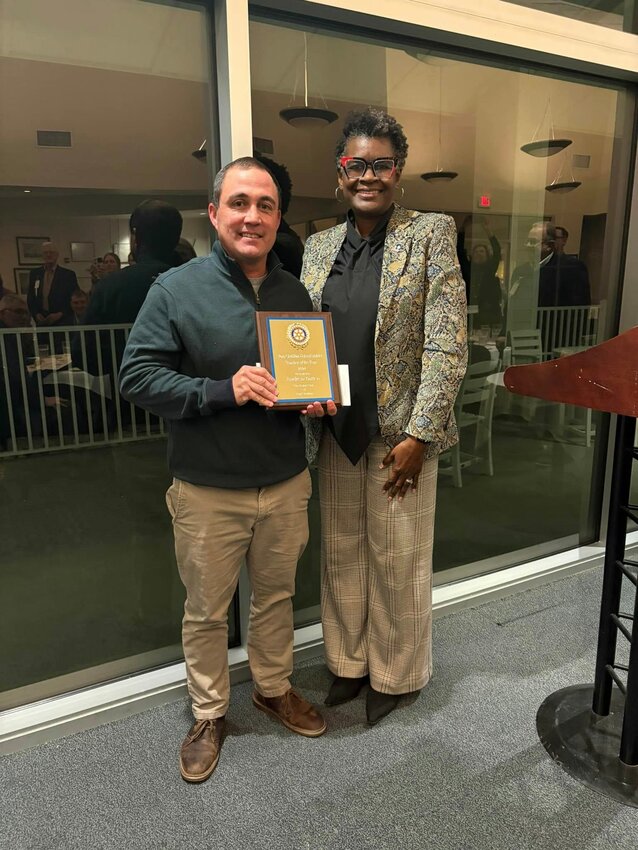 Teacher of the Year Andy Batten (left) is pictured with Pass Christian Schools Superintendent Carla Evers (right).