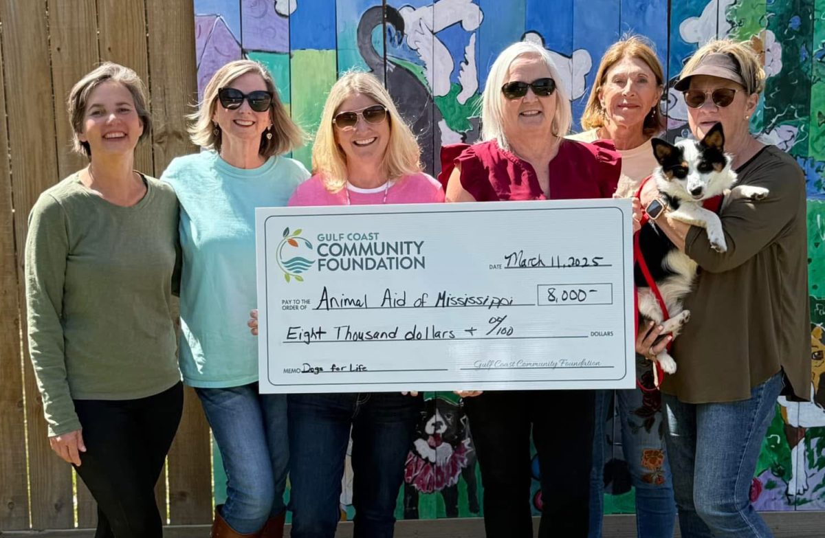 Pictured (l to r) are Anne Cieutat Williford; Renee Wieting; Misty Strickland; Lisa Birmingham, director of Grants and Scholarships at GCCF; Mary Bourdin; Meisha (a pup under the care of Animal AID of Mississippi); and Nanette Griffin.