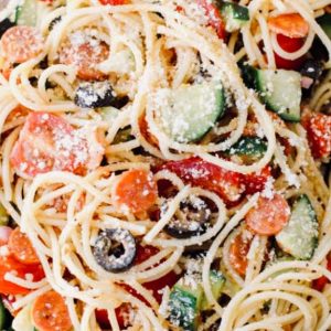 Spaghetti salad, full of chopped vegetables and tangy dressing, is the perfect hot-weather meal or side dish.