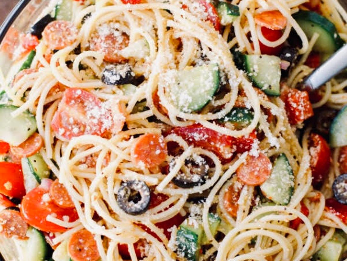 Spaghetti salad, full of chopped vegetables and tangy dressing, is the perfect hot-weather meal or side dish.