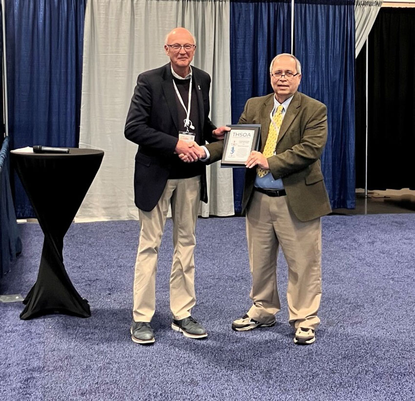 Maxim van Norden (right) is presented with a plaque to commemorate his induction into the U.S. Hydrographer Hall of Fame.