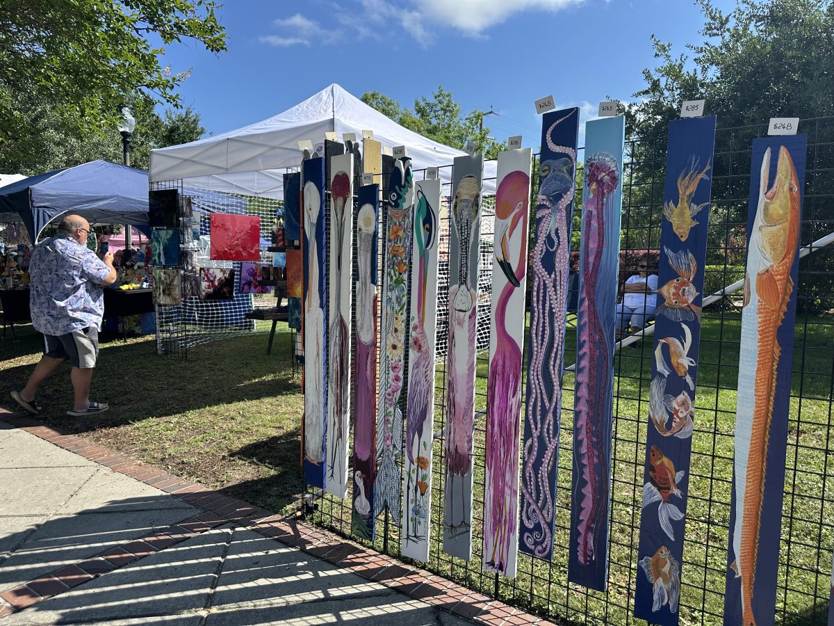 Specialized art and decor, from paintings to embroidery, can be found and purchased at the weekly market. (Photo credit: Toni Miles)