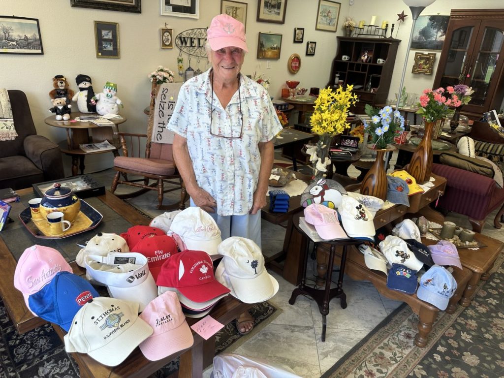 Norma Weeds’ store also offers hats from all around the world, as shown modeled by Weeds. (Photo credit: Toni Miles)