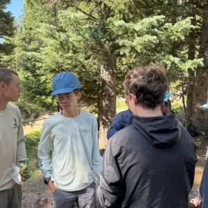 Eagle Scout Addison Carroll, Crew Chief Nate Pyron, Eagle Scout Chase Cockrell and Scout Max Elenbaas take a lunch break while working on their conservation project at Philmont Scout Reservation.