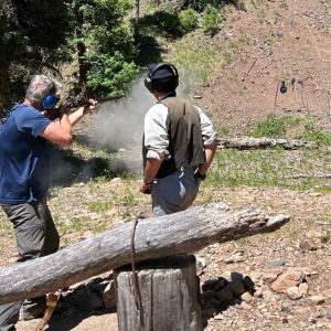 Assistant Scoutmaster Bill Elenbaas fires a black powder rifle at Black Mountain Camp at Philmont Scout Reservation. Adults were able to participate in a few of the activities enjoyed by the Scouts.