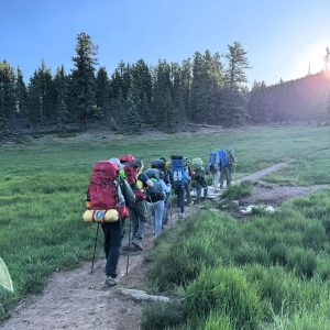 Troop 321 on the trail at Scouting America’s Premier High Adventure base, Philmont Scout Reservation. Philmont offers tremendous bio-diversity and environments, from bald mountains to cactus-rich desert to wet-grassy wetlands to creek-fed slot canyons with dense vegetation.