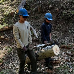 Eagle Scout Addison Carroll and Scout Max Elenbaas work on a conservation project at Philmont Scout Reservation. In addition to backpacking, scouts take a low-mileage day to help maintain the reservation for future generations of scouts. Here, the scouts are reducing fuel for fires on the forest floor, known as “shade-tree-brush-clearing.” This type of clearing will allow professional foresters and fire-fighters the ability to do a controlled burn to further reduce fire-fuel in the forest, maintaining a healthier forest.