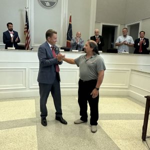 Long Beach Mayor Tim Pierce (left) presents Frank Olaivar with a certificate honoring the local businessman’s twenty-four years of service on the Long Beach Planning and Development Commission.