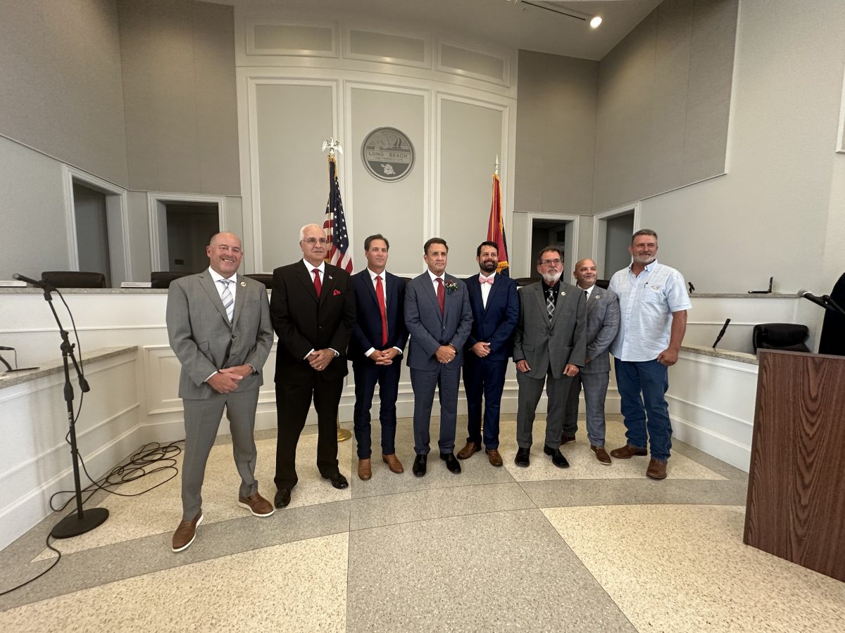 Newly-elected and re-elected Long Beach Aldermen and new Mayor Tim Pierce, now serving four-year terms, pose for a photo on July 1 after the official swearing-in ceremony. Pictured (l to r) are Ward 5 Alderman Greg Bonds, Ward 3 Alderman Joey Giuffria, Ward 1 Alderman Patrick Bennett, Mayor Tim Pierce, Ward 4 Alderman Timothy McCaffrey, Ward 6 Alderman Pete McGoey, Alderman-at-Large Donald Frazer and Ward 2 Alderman Jesse Allen. (Photo credit: Toni Miles)