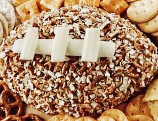 A football-shaped cheeseball filled with cream cheese and favorite additions is the perfect centerpiece for tailgating tables as well as watching the game at home.