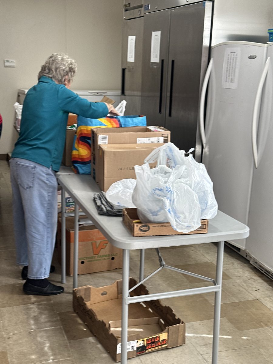 A volunteer packs donated food at the food pantry on Wednesday, November 12.