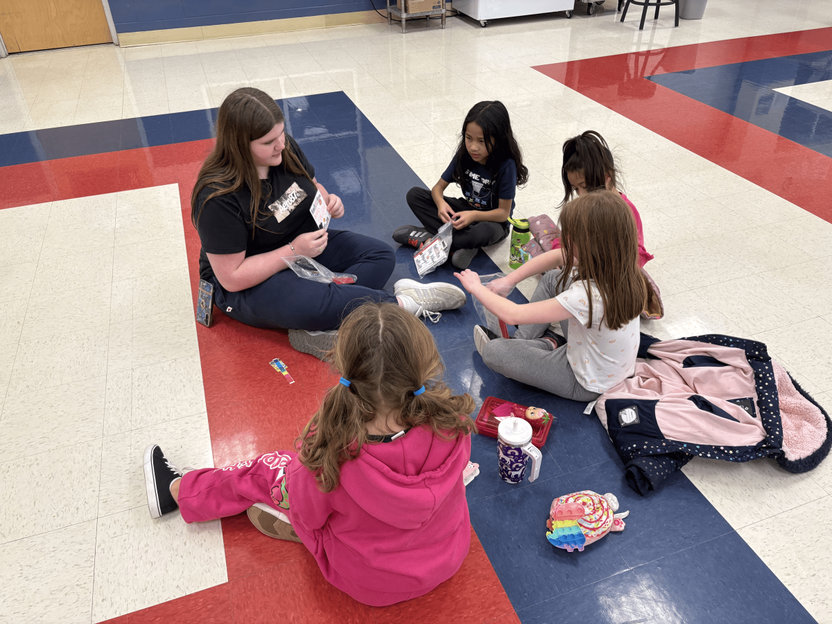 Savannah Layne reading with elementary students