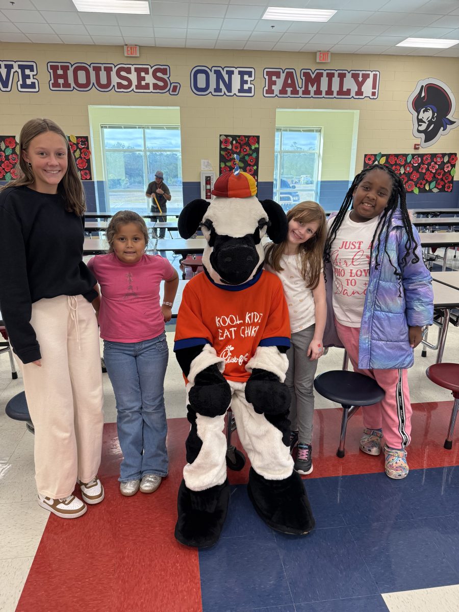Nola Ellis with DES students and Chick-fil-a cow