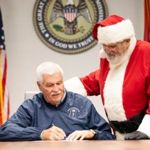 Dr. James Watson, State Veterinarian, issues a certificate of veterinary inspection to Santa Claus, permitting his reindeer to enter and exit the state of Mississippi on Christmas Eve, December 24.