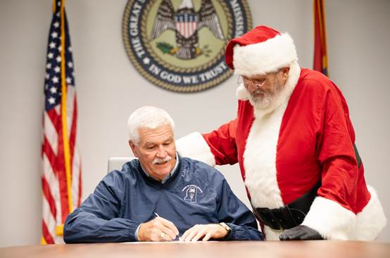 Dr. James Watson, State Veterinarian, issues a certificate of veterinary inspection to Santa Claus, permitting his reindeer to enter and exit the state of Mississippi on Christmas Eve, December 24.