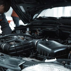 man working under the hood of a car