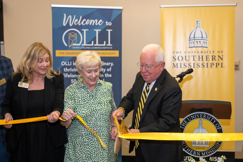 Paula Mathis, Sue Pace and Dr. Joseph Paul cut the ribbon to the new OLLI space at the Gulf Park campus. (Photo credit: Special to Long Beach Breeze)