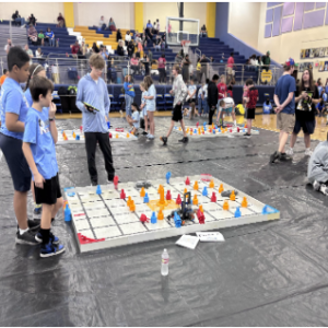 Robotics team tournament champions are pictured with their coach.