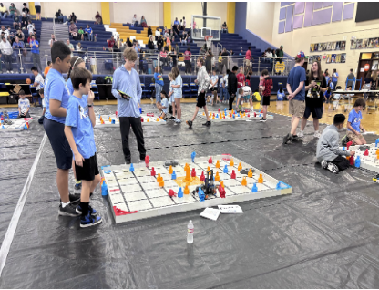 Robotics team tournament champions are pictured with their coach.