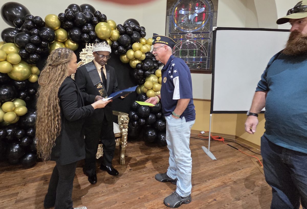 Rick Dew, Commander of the Ssgt. Donnie Leo Levens American Legion Post 1995, presents Robert Thomas, Jr. with a Certificate of Honor from the American Legion.