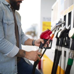 man getting gas at a gas station