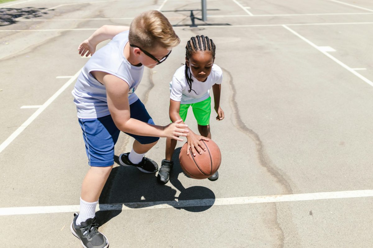 two kids playing basketball