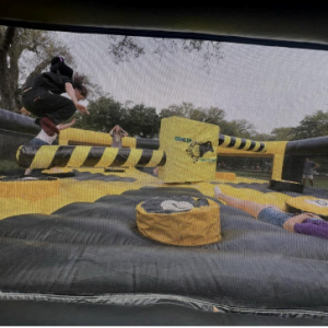 Students taking on the Wipeout Inflatable to unlock their inner Ninja Warrior
