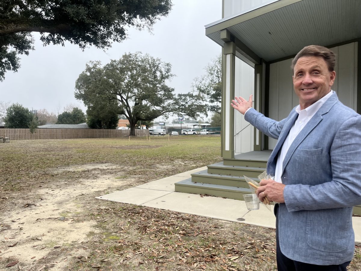 Long Beach Mayor Tim Pierce motions to a site where a garden will soon be planted on the historic grounds of Greenvale.