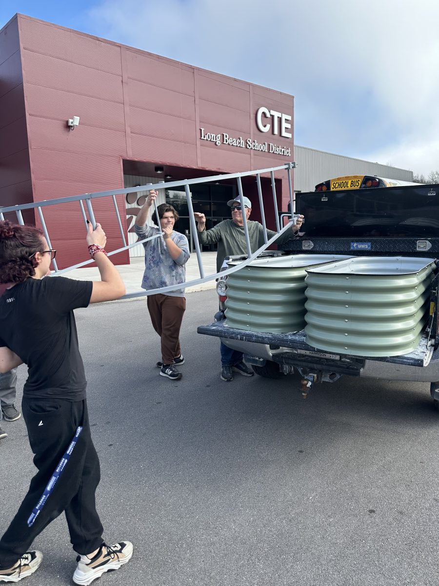 Local students and scouts helped with some of the work required to assemble and place the beds.