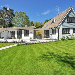 beautiful white house with green grass