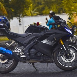blue and black motorcycle parked in parking lot