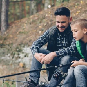 father and son bonding while fishing outdoors