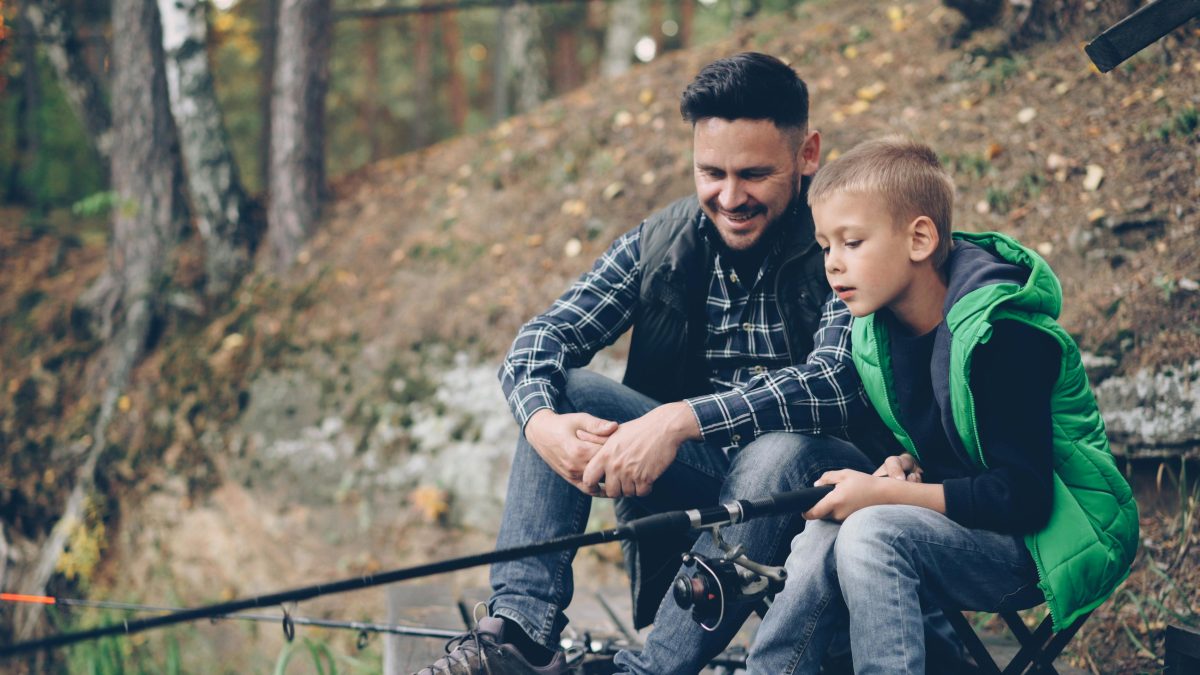 father and son bonding while fishing outdoors
