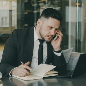 businessman-multitasking-in-urban-cafe-setting