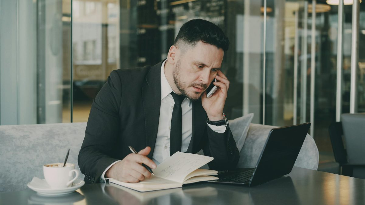 businessman-multitasking-in-urban-cafe-setting