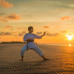 boy doing karate routine during golden hour