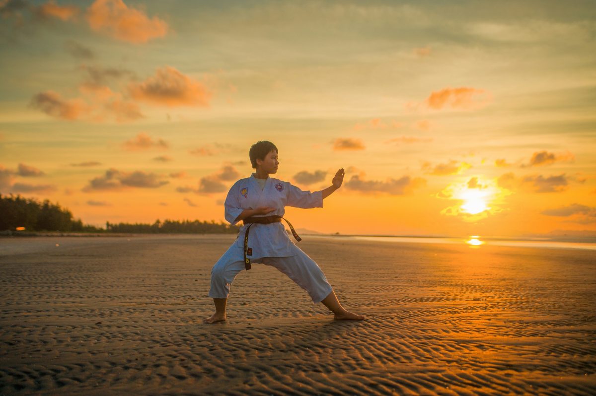 boy doing karate routine during golden hour