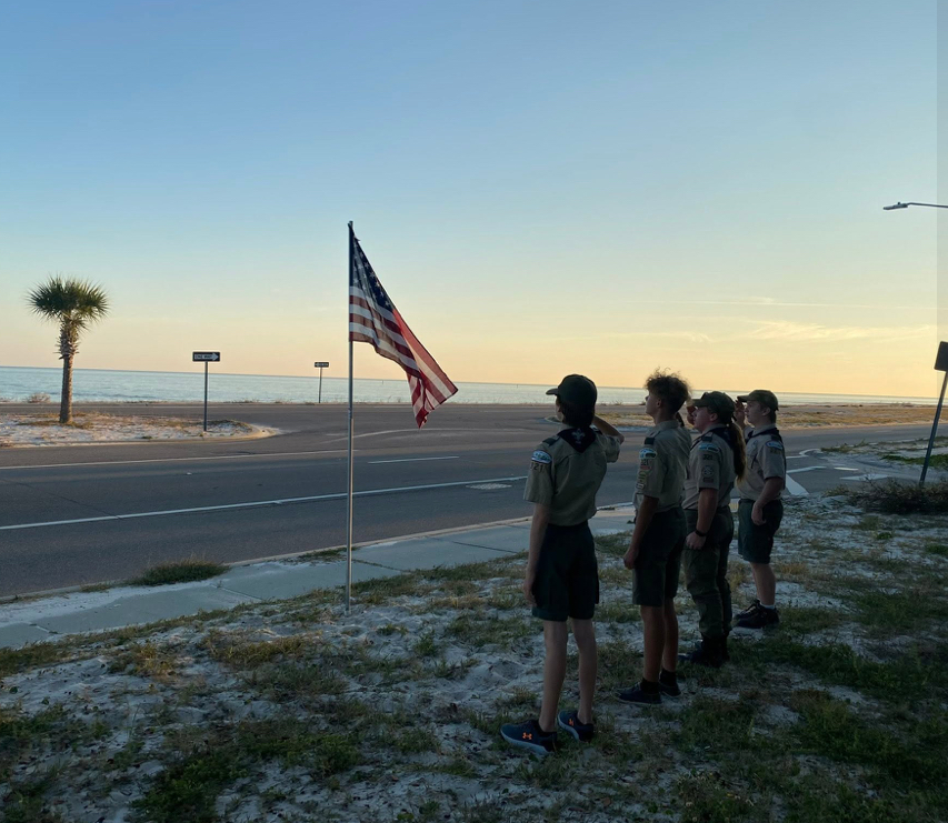 Members of Boy Scouts Troop 321 salute the American flag. This is one of many flags Boy Scouts with this local troop put up throughout the City of Long Beach for Memorial Day.