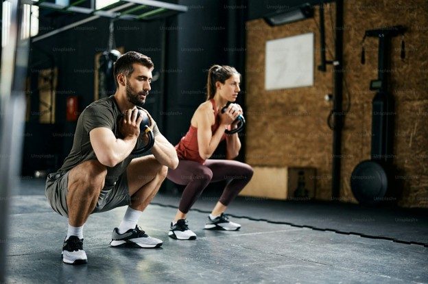 young athletes using kettlebells in a gym