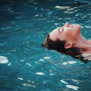 woman floating in a body of water