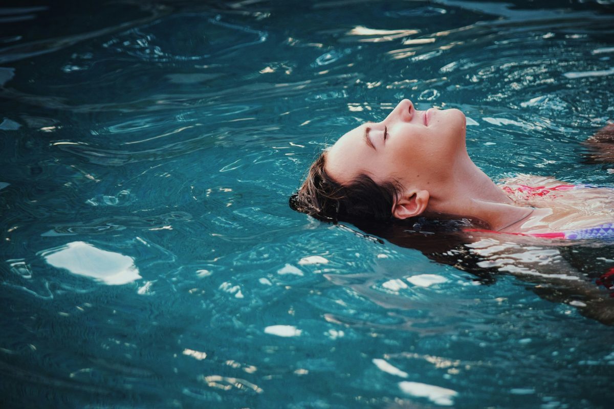 woman floating in a body of water