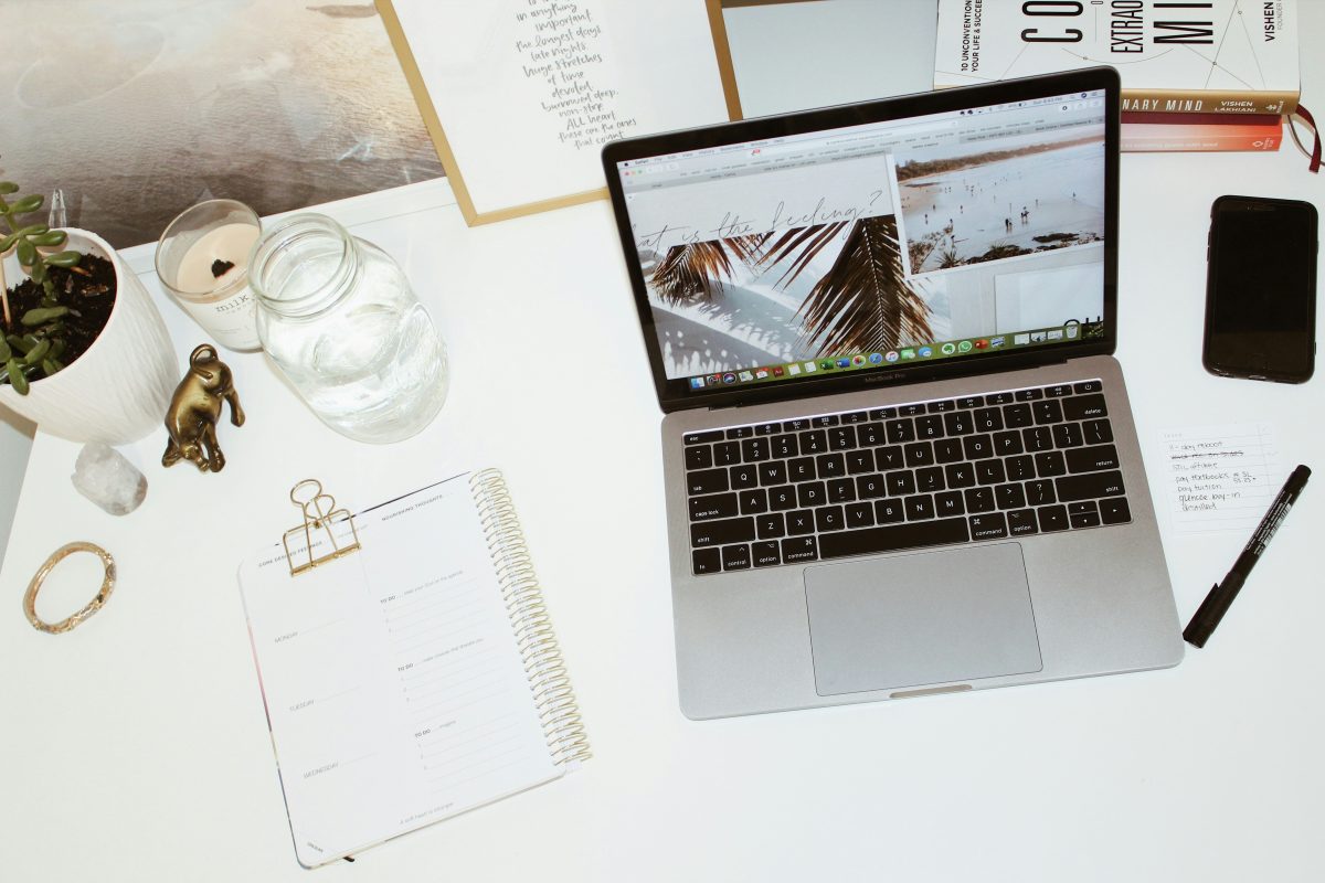 laptop computer sitting on top of white desk