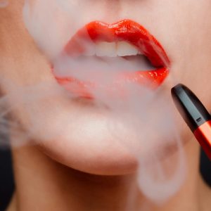 close up of woman's lips with smoke
