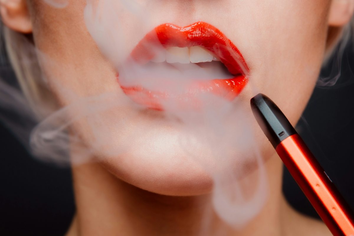 close up of woman's lips with smoke