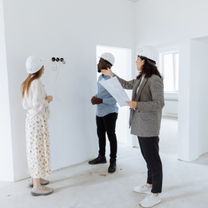 professionals looking at wires in wall