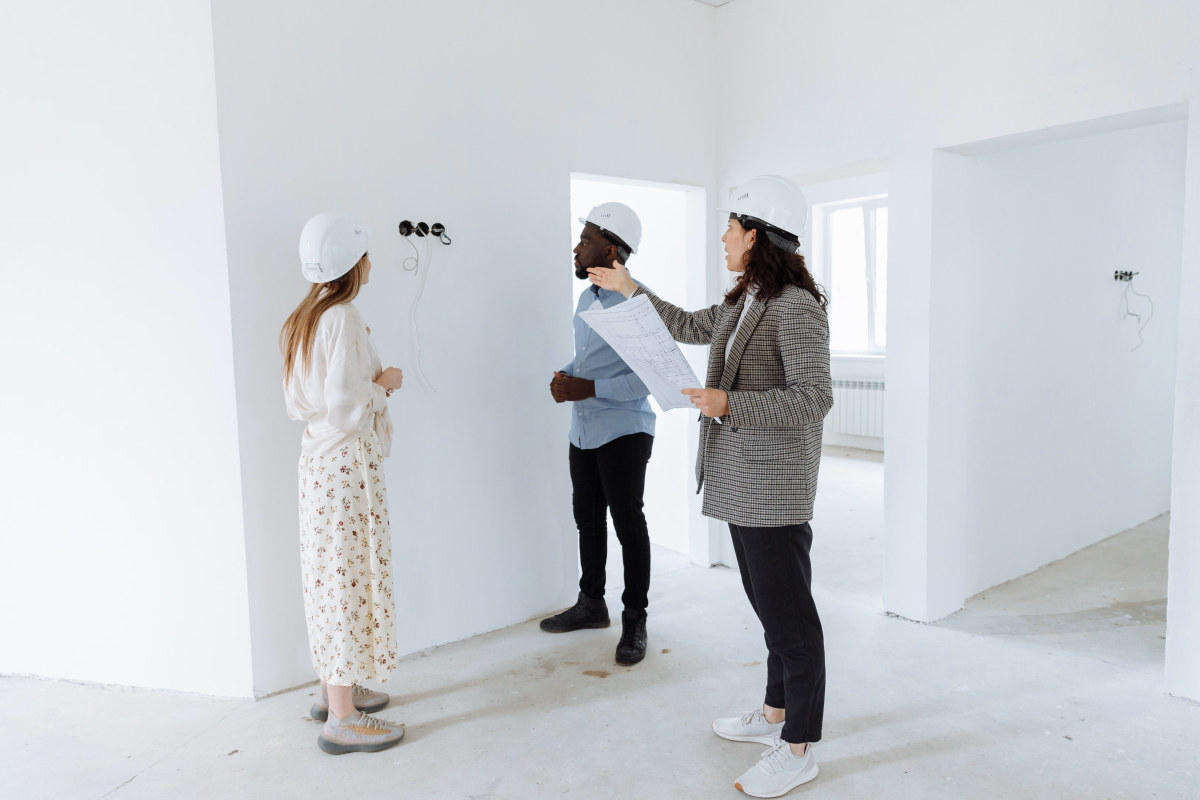 professionals looking at wires in wall