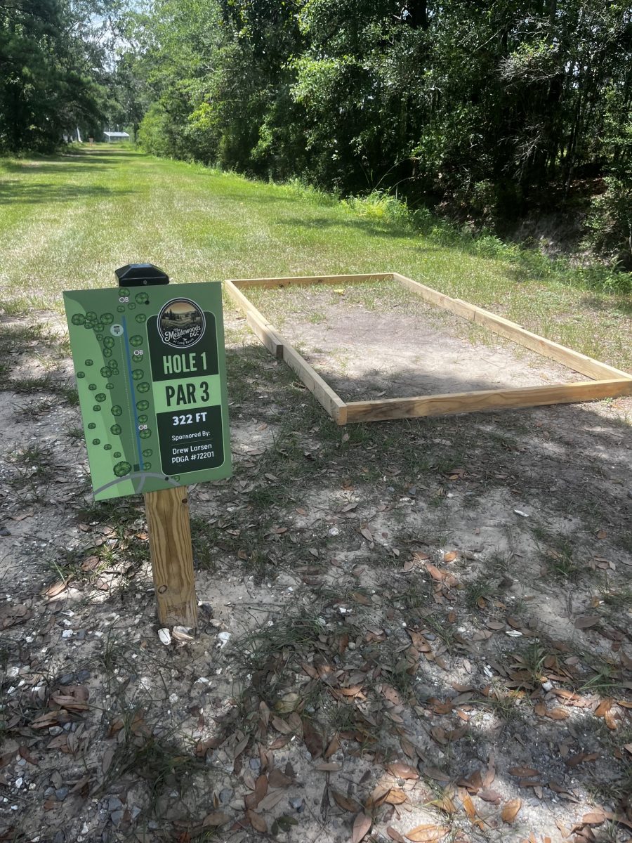 Seabee volunteers from the local Naval Construction Battalion Center helped lay the concrete for the course’s tee pads on July 11 and also provided signage. (Photo credit: Toni Miles)
