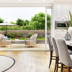 A view from inside an open floor plan home looking out onto the patio, including the kitchen and dining area.