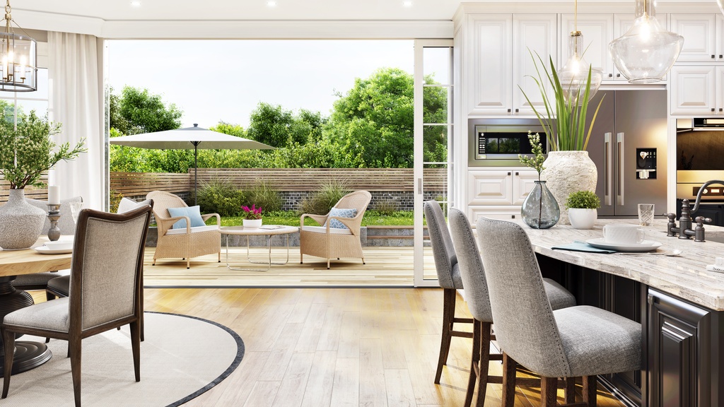 A view from inside an open floor plan home looking out onto the patio, including the kitchen and dining area.