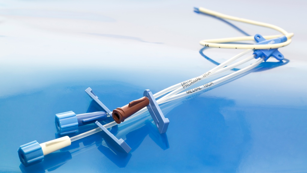A triple-lumen central venous catheter has clear tubes and three colored ports—brown, blue, and white.